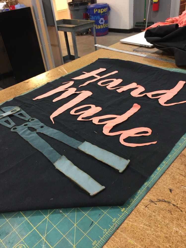 A hand-sewn 'Hand Made' fabric banner.