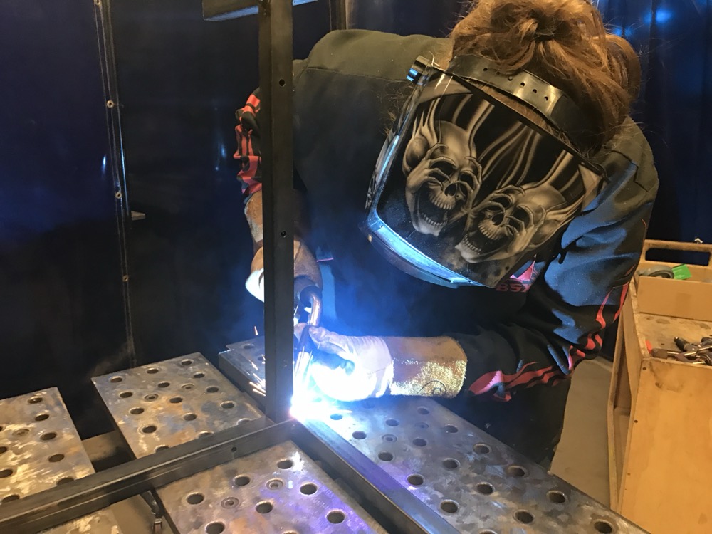Welding metal in a fabrication shop.